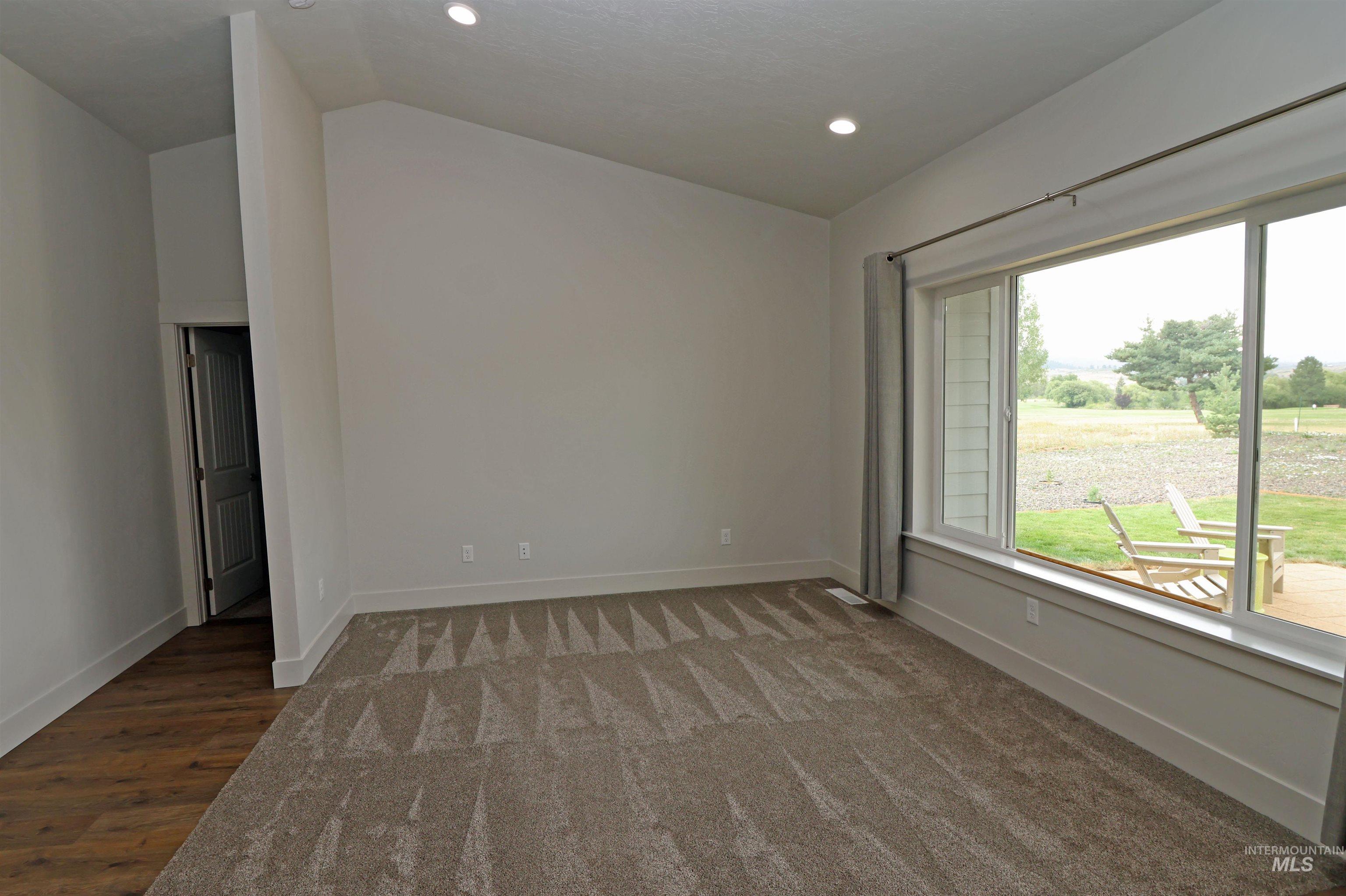 2272 Golf Lane Council, ID 83612 - Photo 12 of 32 Spare room with vaulted ceiling, recessed lighting, and carpet flooring