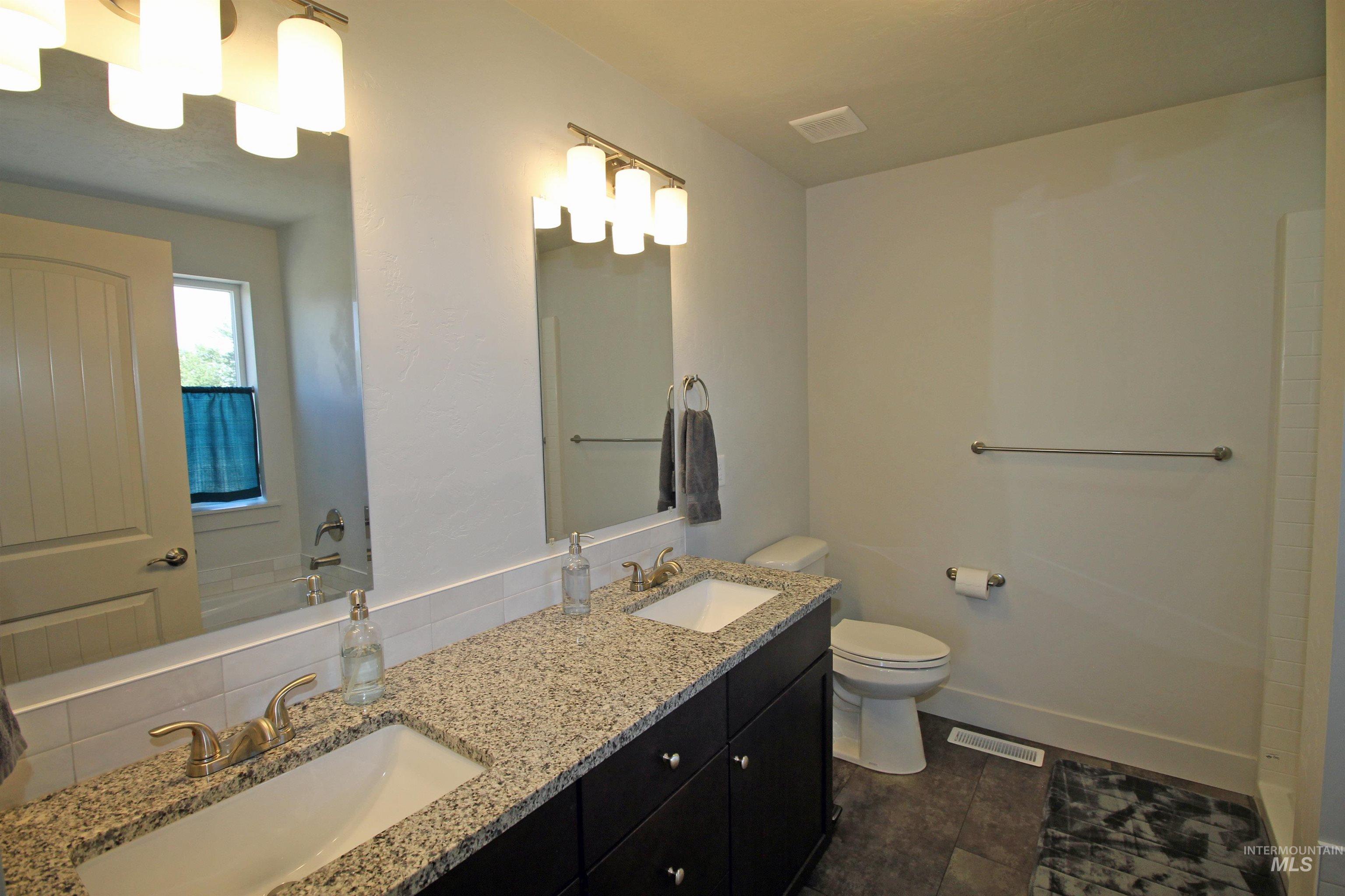 2272 Golf Lane Council, ID 83612 - Photo 16 of 32 Bathroom with double vanity and tile patterned flooring