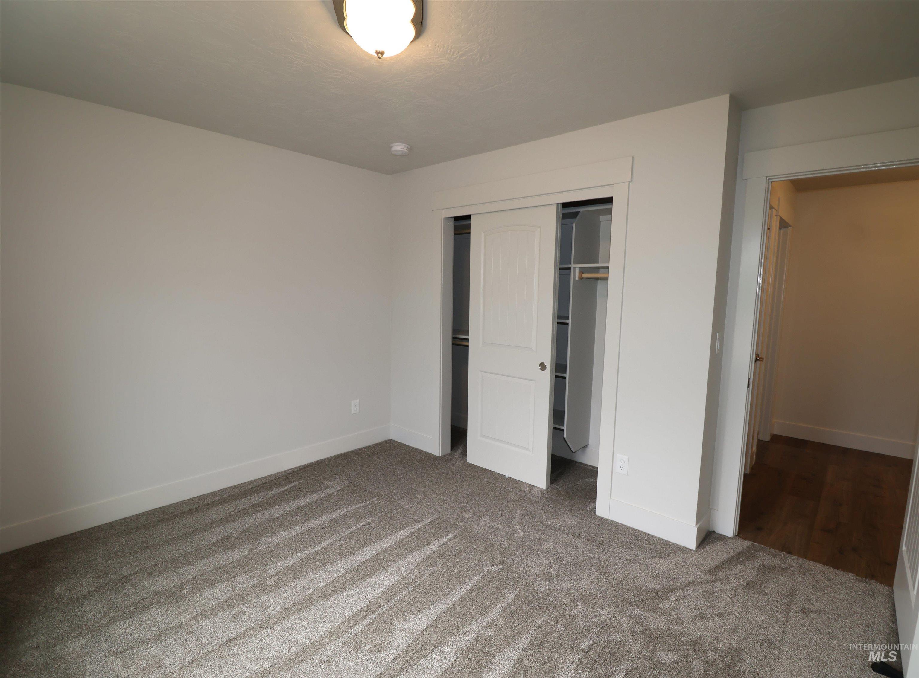 2272 Golf Lane Council, ID 83612 - Photo 19 of 32 Unfurnished bedroom with carpet flooring and a closet