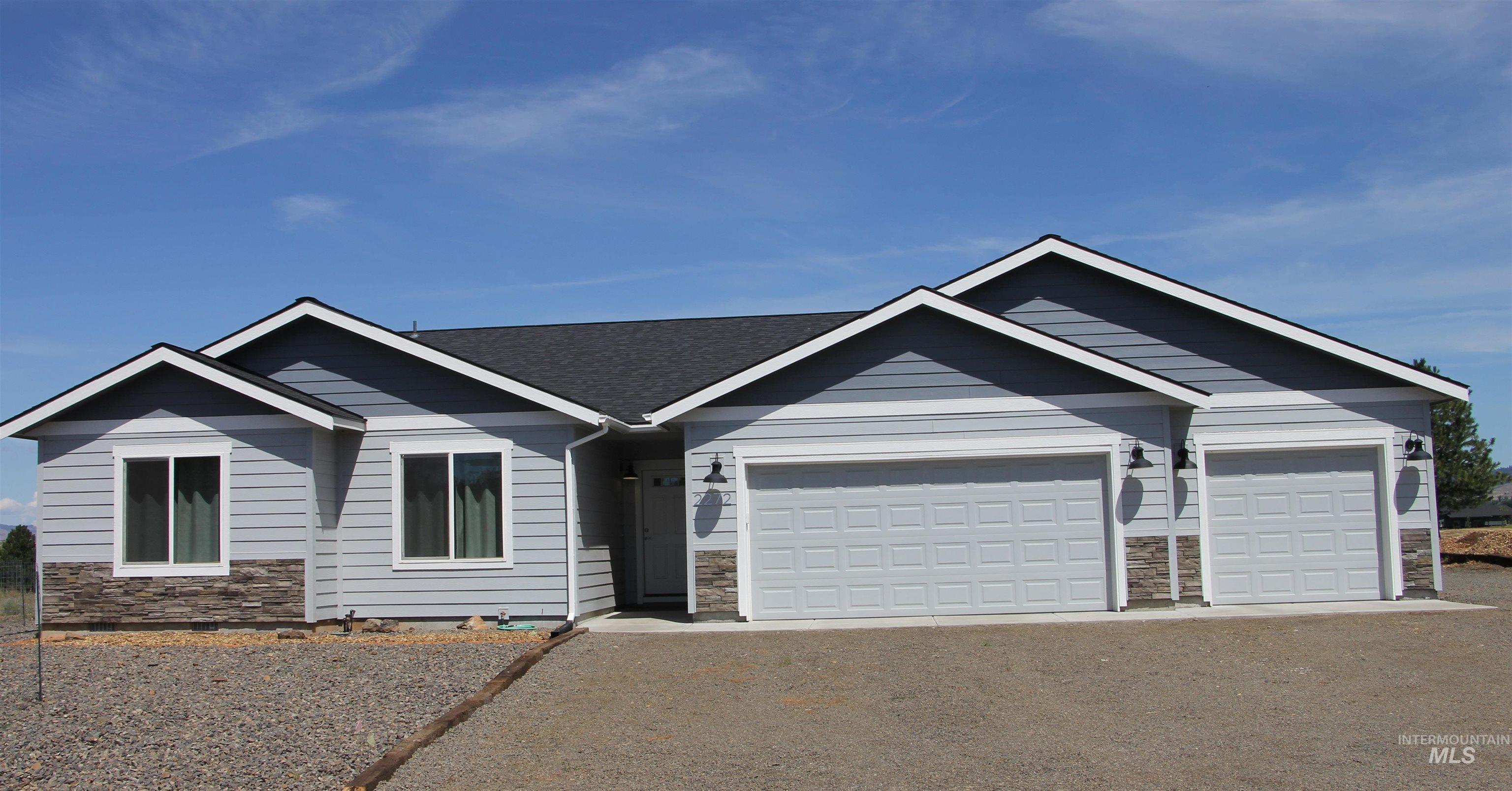 2272 Golf Lane Council, ID 83612 - Photo 2 of 32 Single story home featuring stone siding, driveway, and a garage
