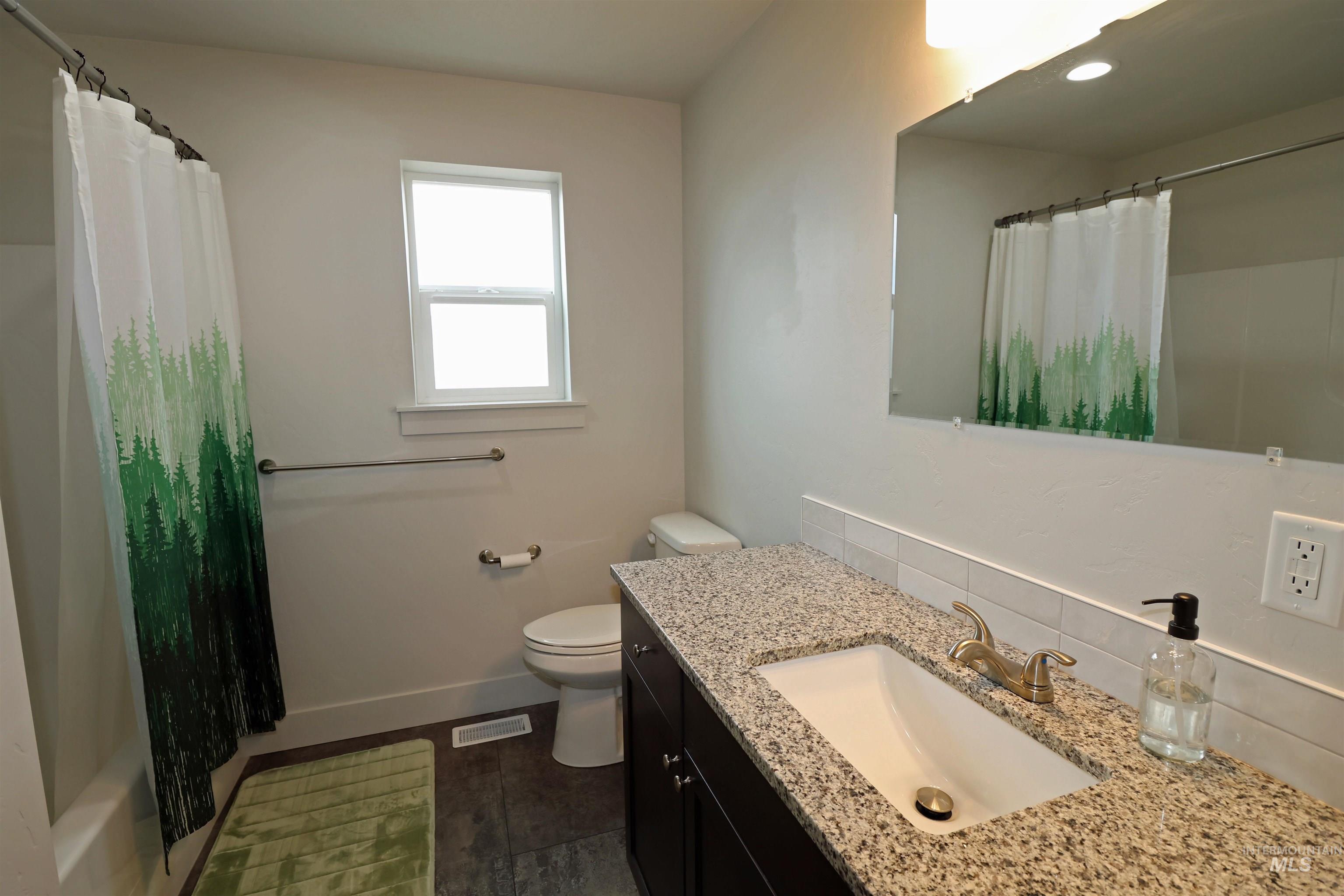 2272 Golf Lane Council, ID 83612 - Photo 20 of 32 Bathroom featuring vanity and shower / tub combo with curtain