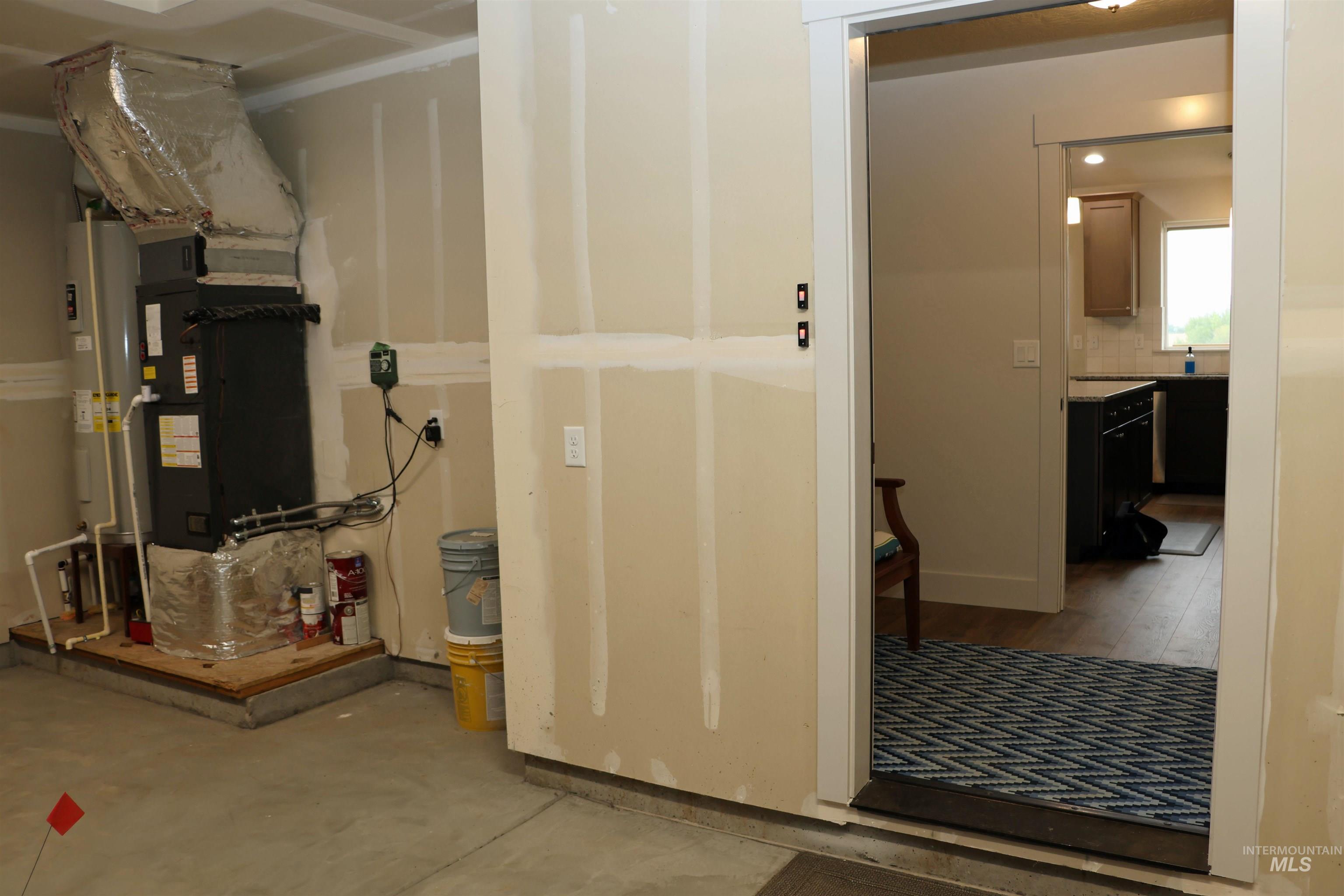 2272 Golf Lane Council, ID 83612 - Photo 26 of 32 Utility room with heating unit and water heater