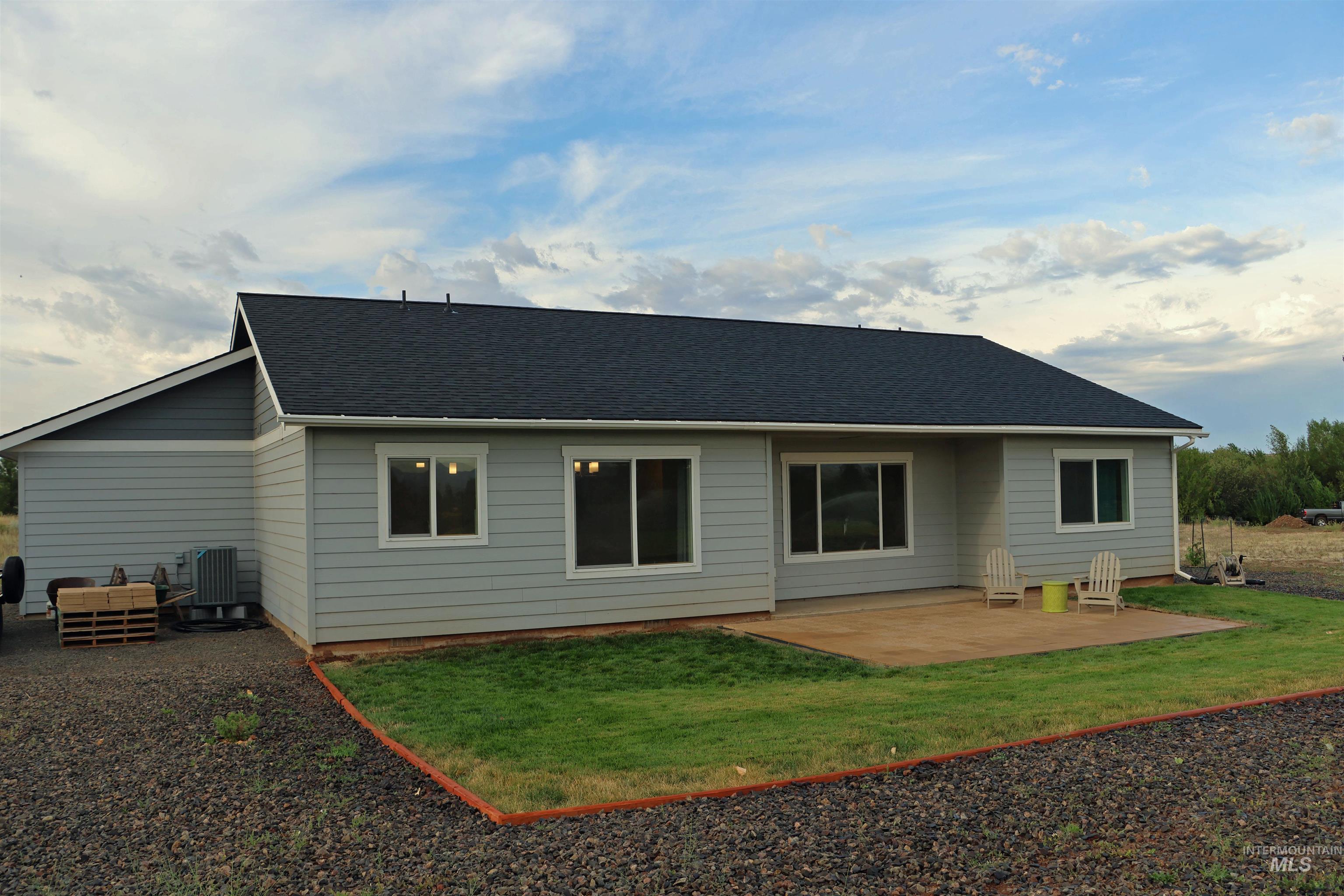 2272 Golf Lane Council, ID 83612 - Photo 27 of 32 Rear view of property with a patio area, a yard, and a shingled roof
