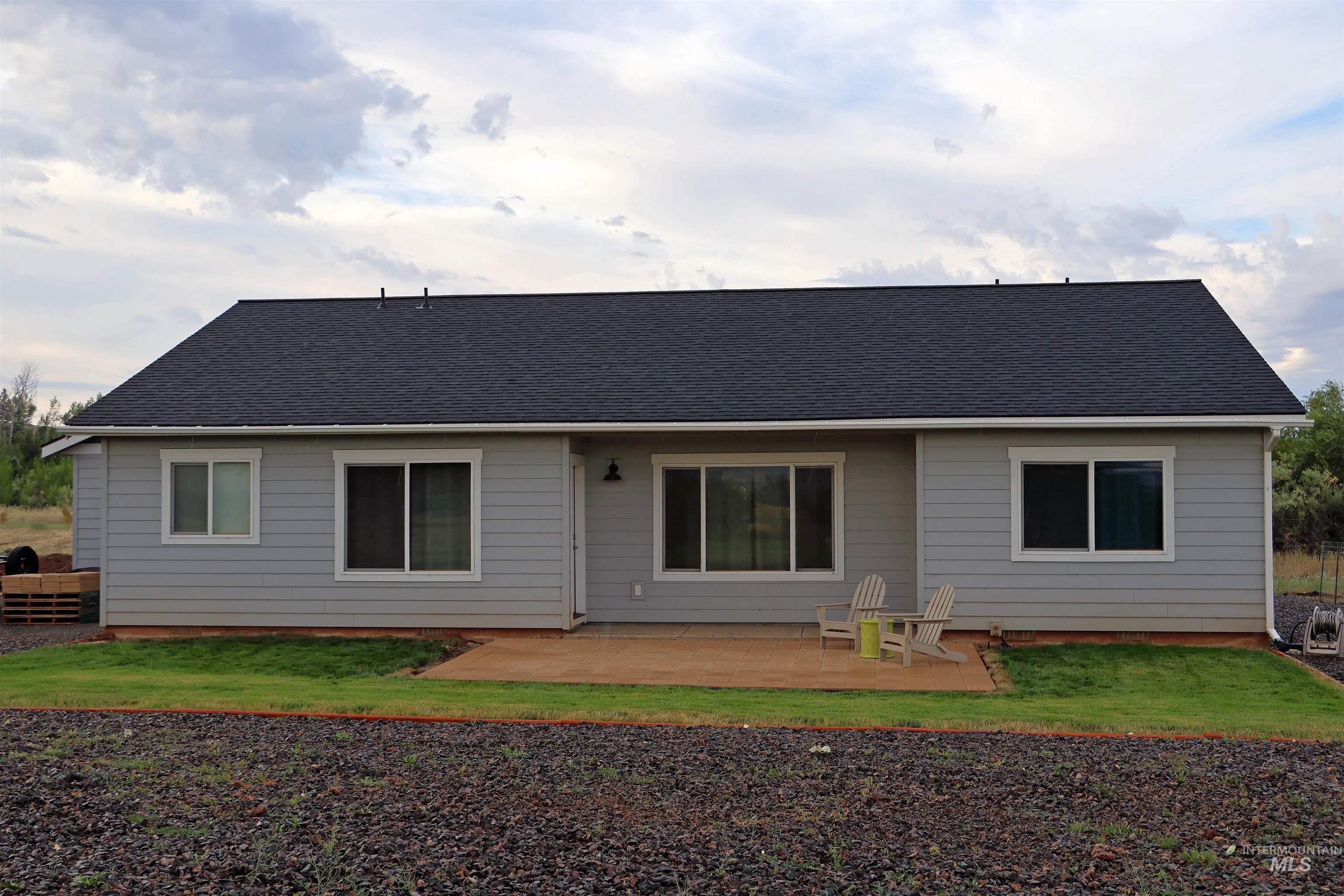 2272 Golf Lane Council, ID 83612 - Photo 4 of 32 Back of property with a patio area, a shingled roof, and a yard