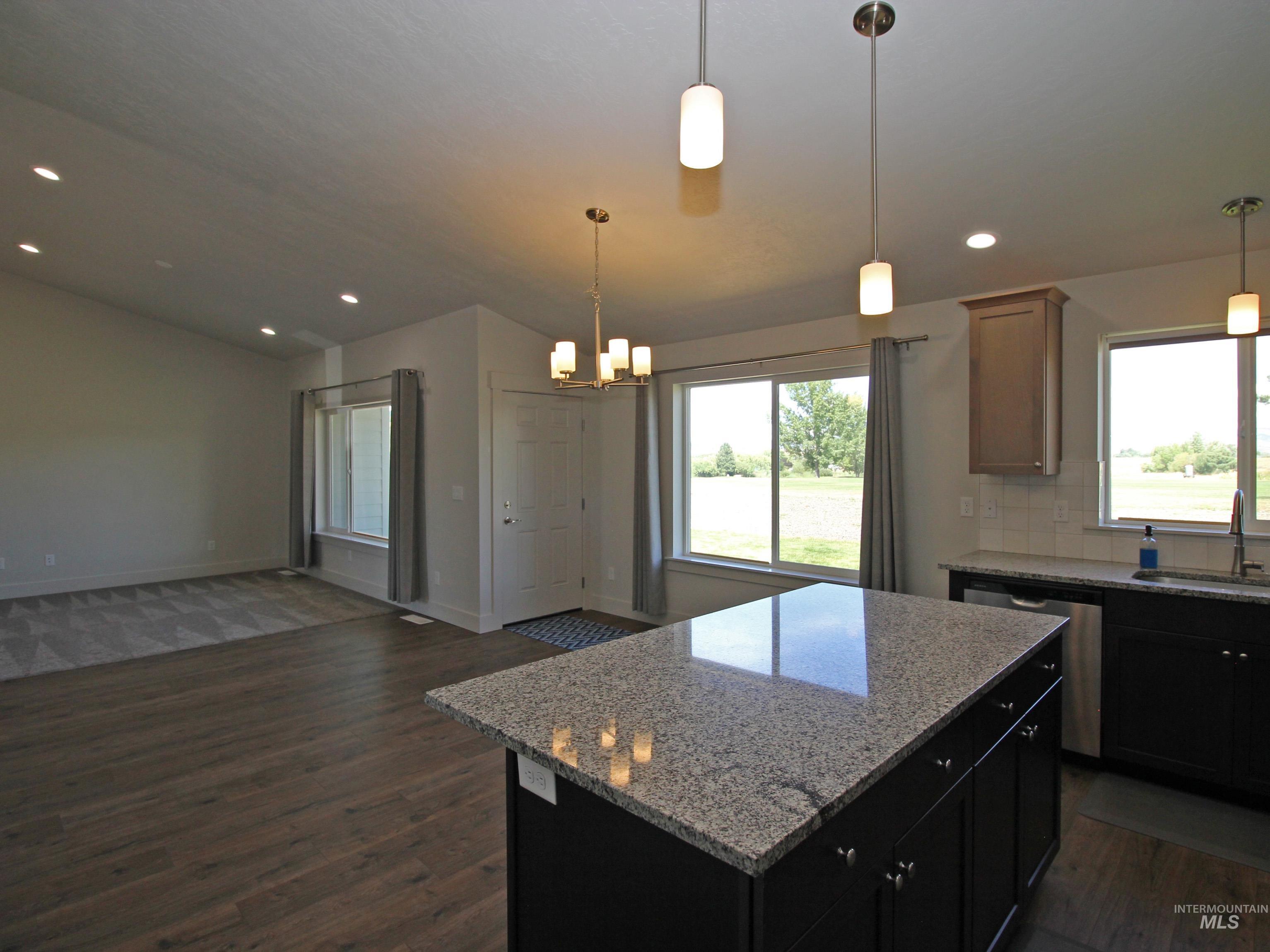 2272 Golf Lane Council, ID 83612 - Photo 32 of 32 Kitchen featuring lofted ceiling, open floor plan, dark wood-style flooring, a center island, and recessed lighting
