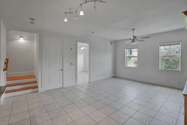 an empty room with windows and closet