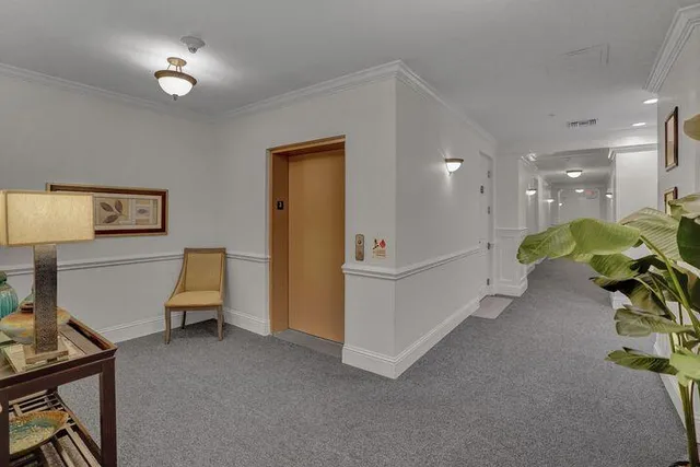 a view of a livingroom with furniture and a workspace