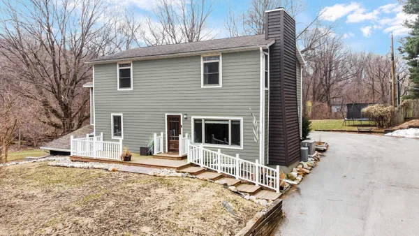 a view of a house with a yard covered in snow