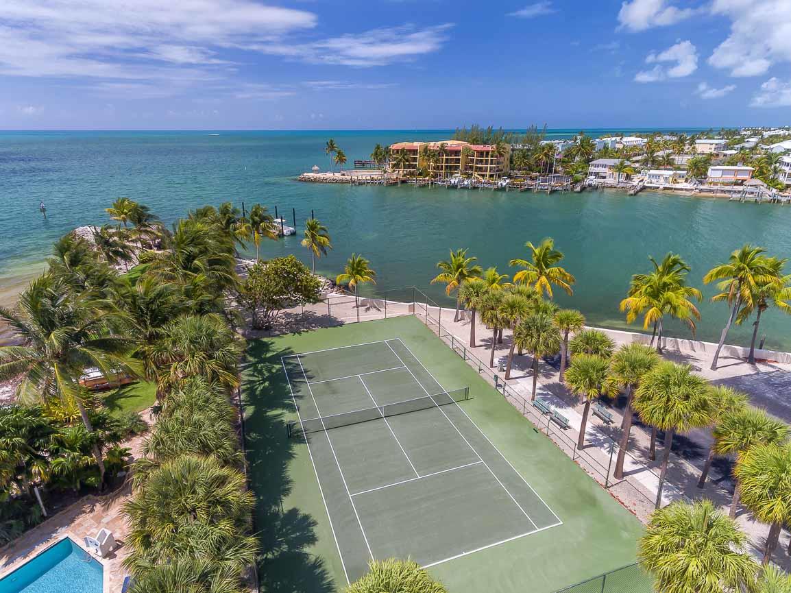 2000 Coco Plum Drive, Unit 404 Marathon, FL 33050 - Photo 14 of 23 a view of a lake with a house