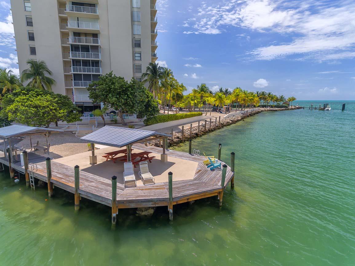 2000 Coco Plum Drive, Unit 404 Marathon, FL 33050 - Photo 15 of 23 a small swimming pool with outdoor seating and lake