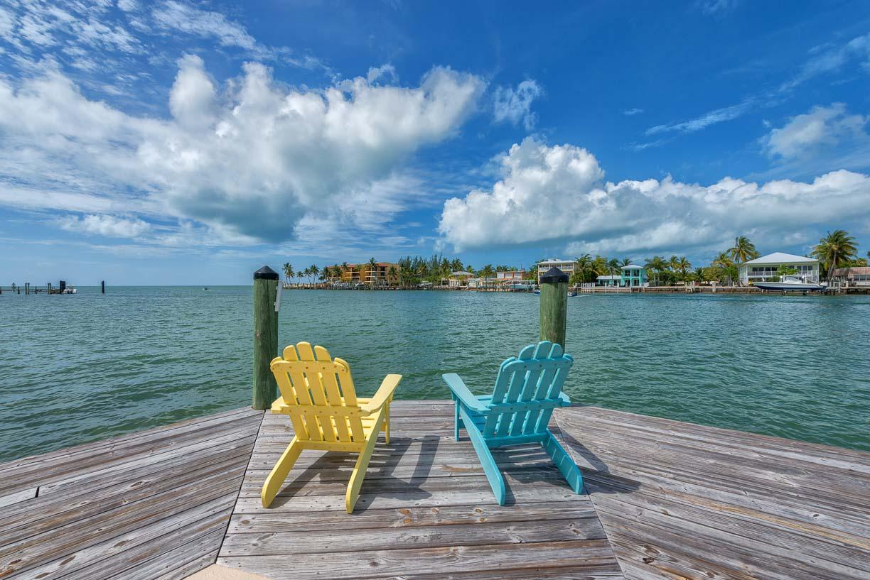 2000 Coco Plum Drive, Unit 404 Marathon, FL 33050 - Photo 16 of 23 a view of a lake with couches in the patio