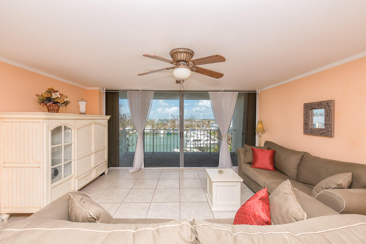 2000 Coco Plum Drive, Unit 404 Marathon, FL 33050 - Photo 4 of 23 a living room with furniture and a chandelier