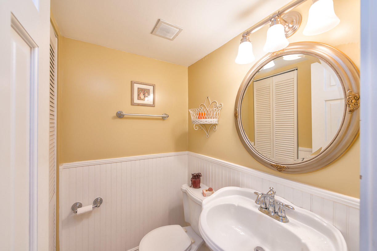 2000 Coco Plum Drive, Unit 404 Marathon, FL 33050 - Photo 7 of 23 a bathroom with a sink a mirror a toilet and a window