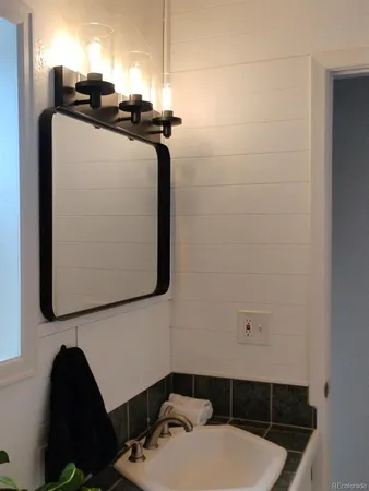 a bathroom with a sink a toilet and mirror