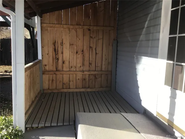 a view of a balcony with wooden floor