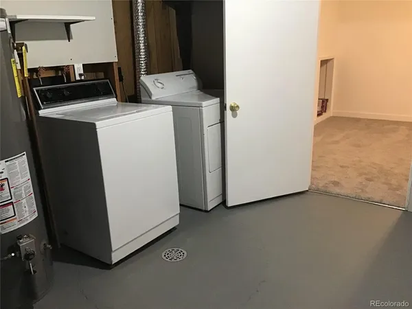 a view of storage and utility room with washer and dryer