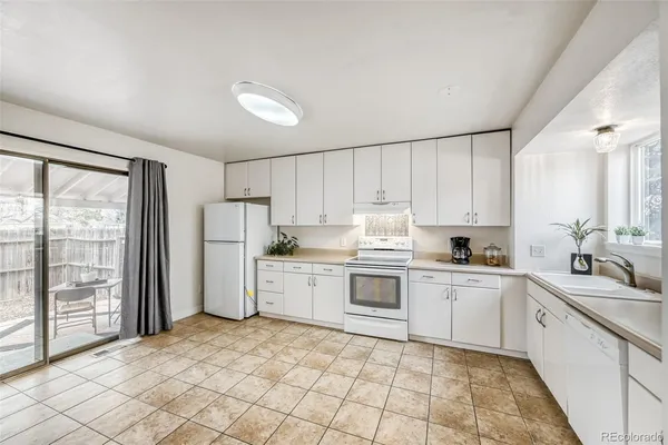 a kitchen with appliances cabinets and a sink