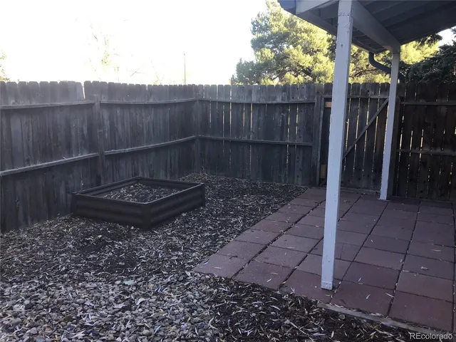 a view of a backyard with a small cabin and a chair