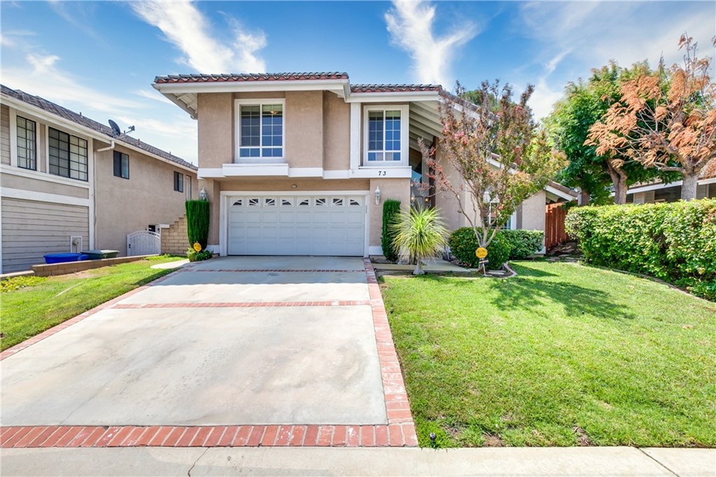 73 Rising Hill Road Phillips Ranch, CA 91766 - Photo 1 of 1 a front view of a house with a yard and garage