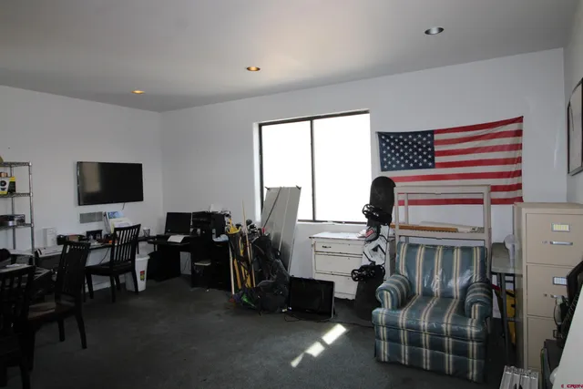 a room with furniture a rug and a window