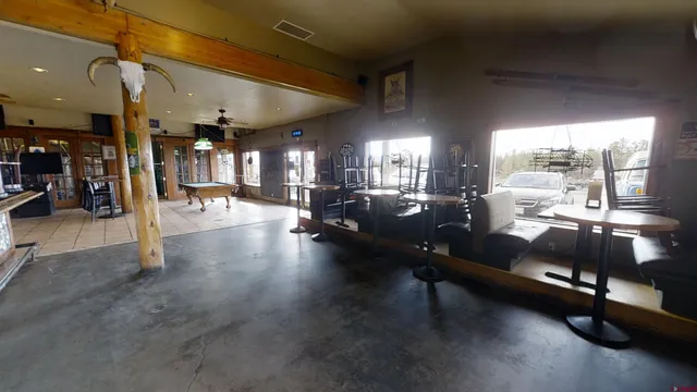 a living room with lots of furniture and view of kitchen