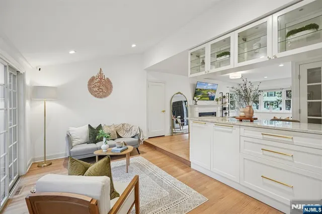 a living room with furniture and kitchen view