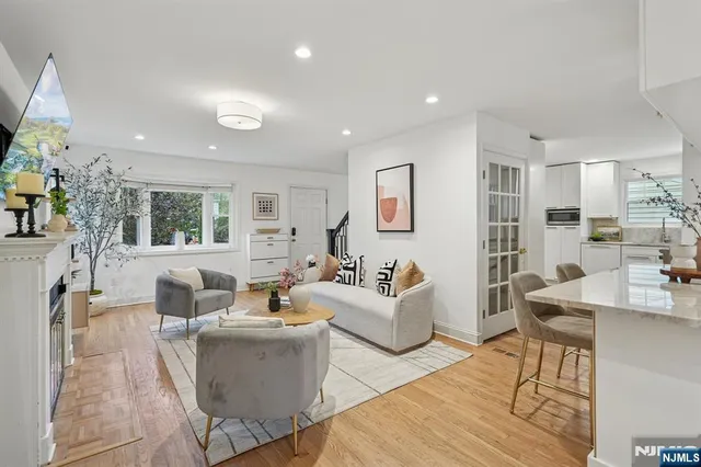 a living room with fireplace furniture and a wooden floor