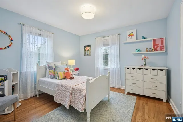 a bed room with furniture and a baby crib