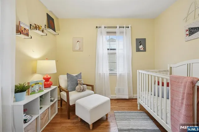 a bedroom with furniture and wooden floor