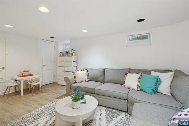 a living room with furniture and a dining table with rug