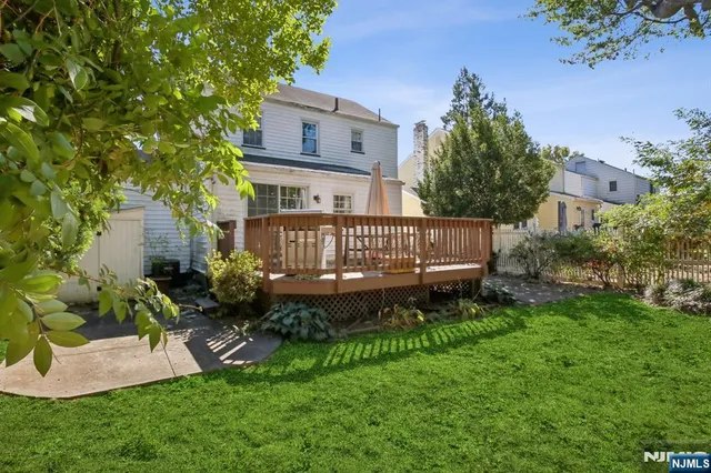 a view of a house with a yard and sitting area