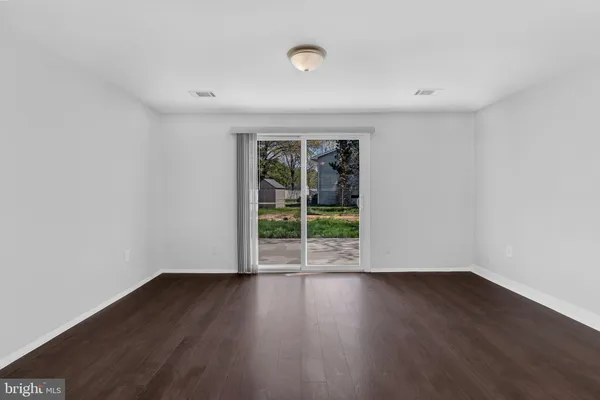 a view of wooden floor and windows in a room