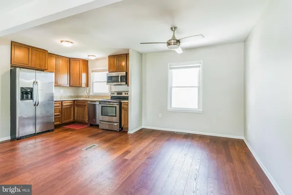 a kitchen with stainless steel appliances a stove a sink and a refrigerator