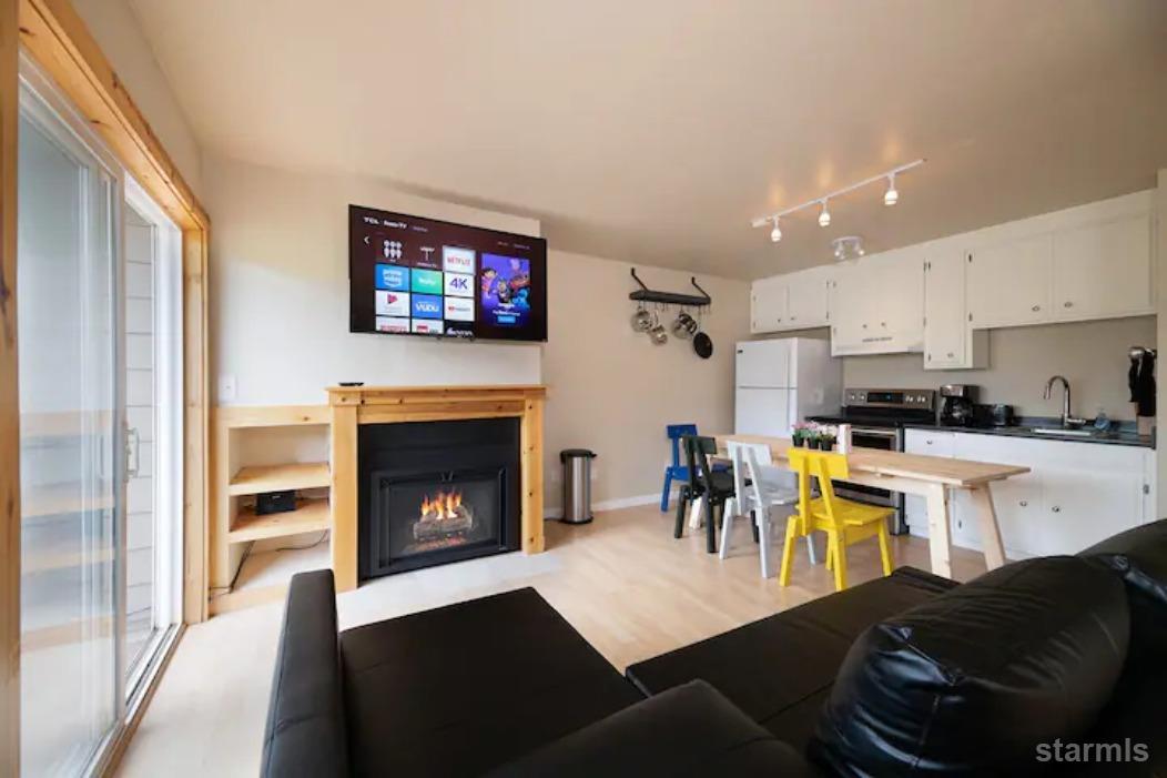 115 Tramway Drive, Unit 1 Stateline, NV 89449 - Photo 11 of 20 a living room with stainless steel appliances furniture a fireplace a flat screen tv and a fireplace
