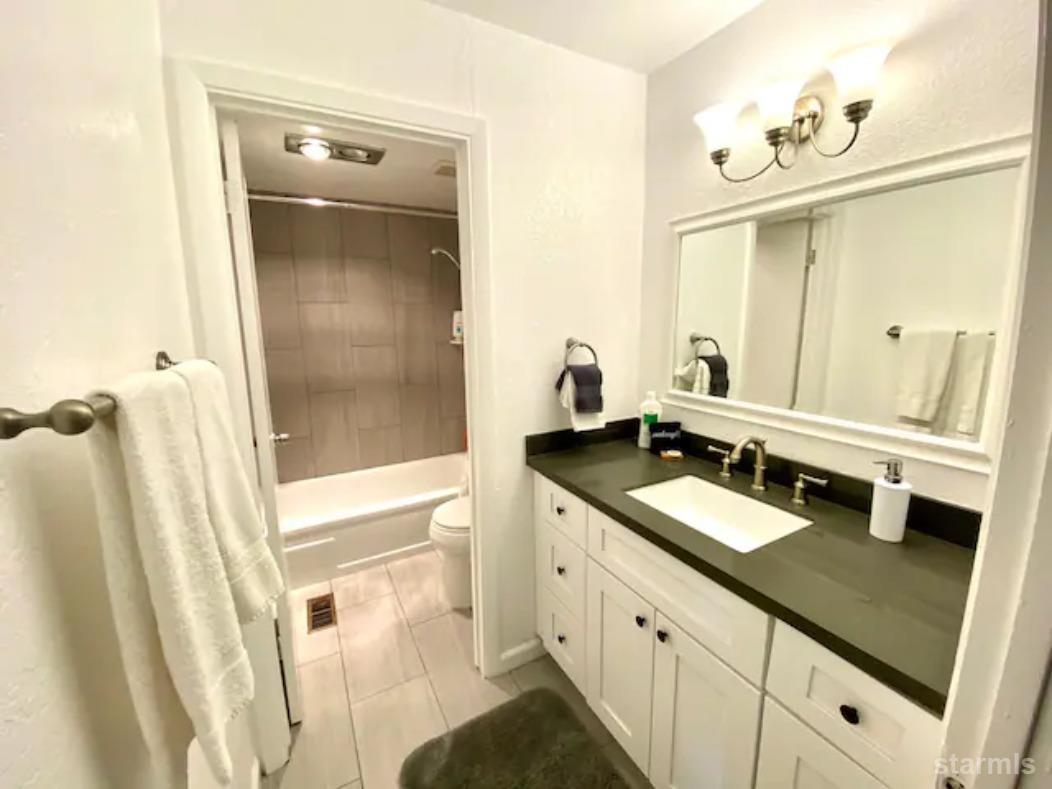 115 Tramway Drive, Unit 1 Stateline, NV 89449 - Photo 12 of 20 a bathroom with a double vanity sink and mirror