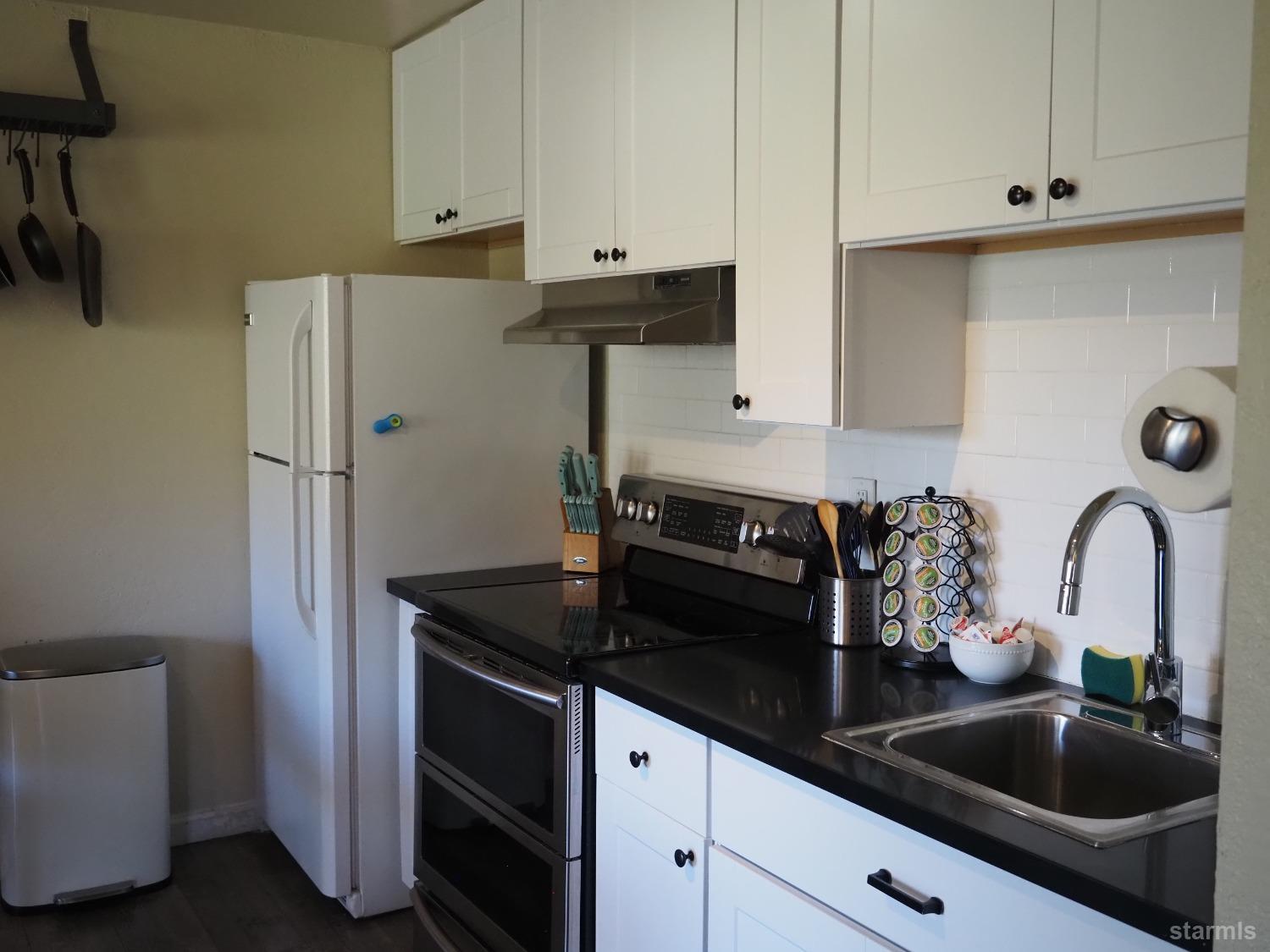 115 Tramway Drive, Unit 1 Stateline, NV 89449 - Photo 5 of 20 a kitchen with a sink and cabinets