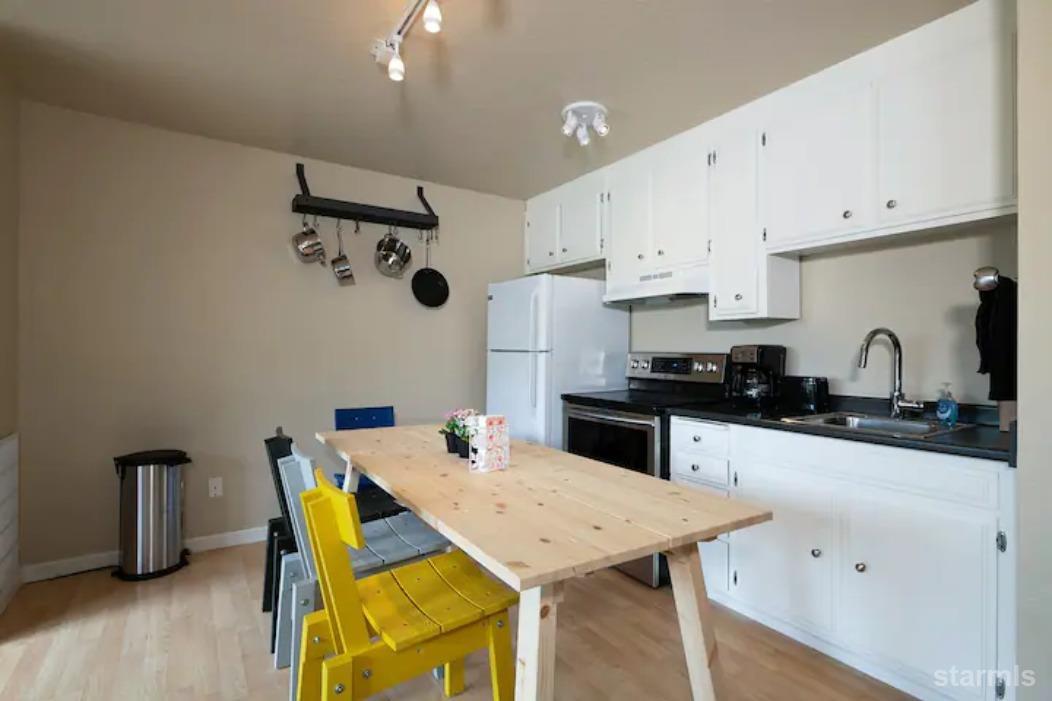 115 Tramway Drive, Unit 1 Stateline, NV 89449 - Photo 7 of 20 a kitchen with a table chairs and a refrigerator