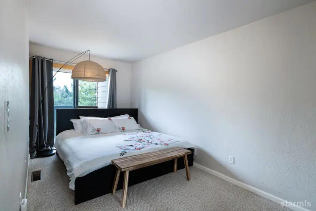 115 Tramway Drive, Unit 1 Stateline, NV 89449 - Photo 9 of 20 a bedroom with a bed and window