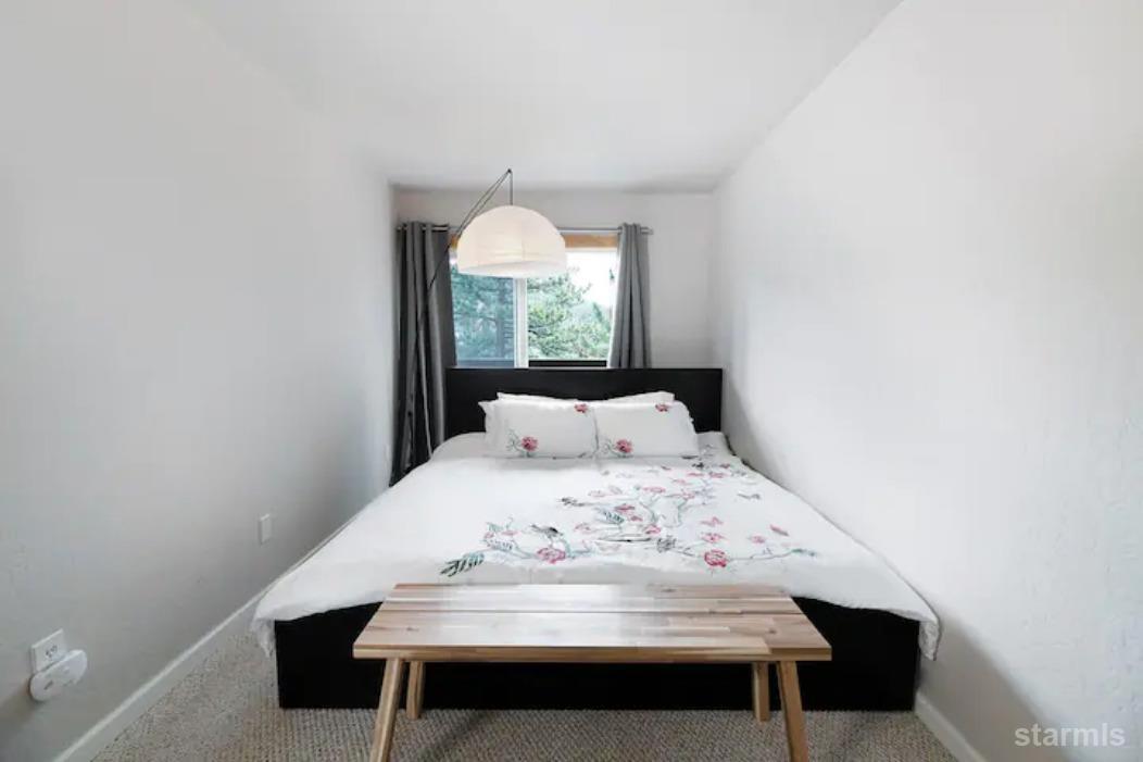 115 Tramway Drive, Unit 1 Stateline, NV 89449 - Photo 10 of 20 a view of a bedroom with a bed and a window
