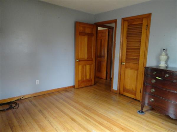 25 Canton Street Springfield, MA 01104 - Photo 14 of 24 an empty room with wooden floor and closet