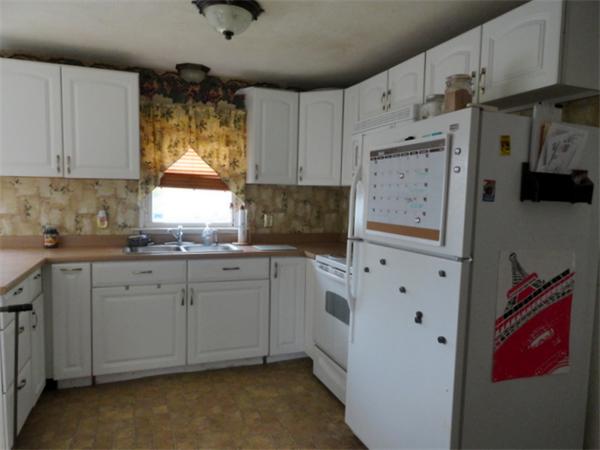 25 Canton Street Springfield, MA 01104 - Photo 5 of 24 a kitchen with granite countertop a white stove top oven sink and cabinets