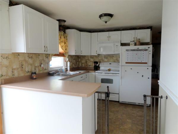 25 Canton Street Springfield, MA 01104 - Photo 6 of 24 a kitchen with cabinets a sink and white appliances