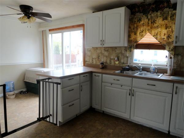 25 Canton Street Springfield, MA 01104 - Photo 8 of 24 a kitchen with a sink appliances cabinets and a window