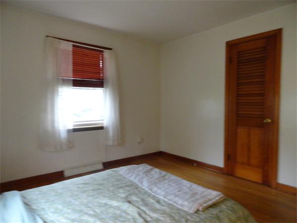 25 Canton Street Springfield, MA 01104 - Photo 10 of 24 an empty room with wooden floor and windows