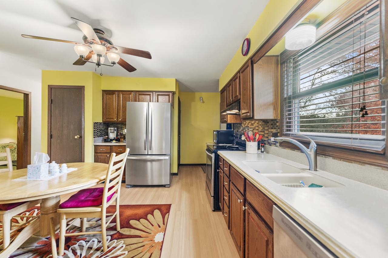 295 Forestcliff Court Lake Summerset, IL 61019 - Photo 11 of 30 a kitchen with kitchen island granite countertop a sink appliances and cabinets
