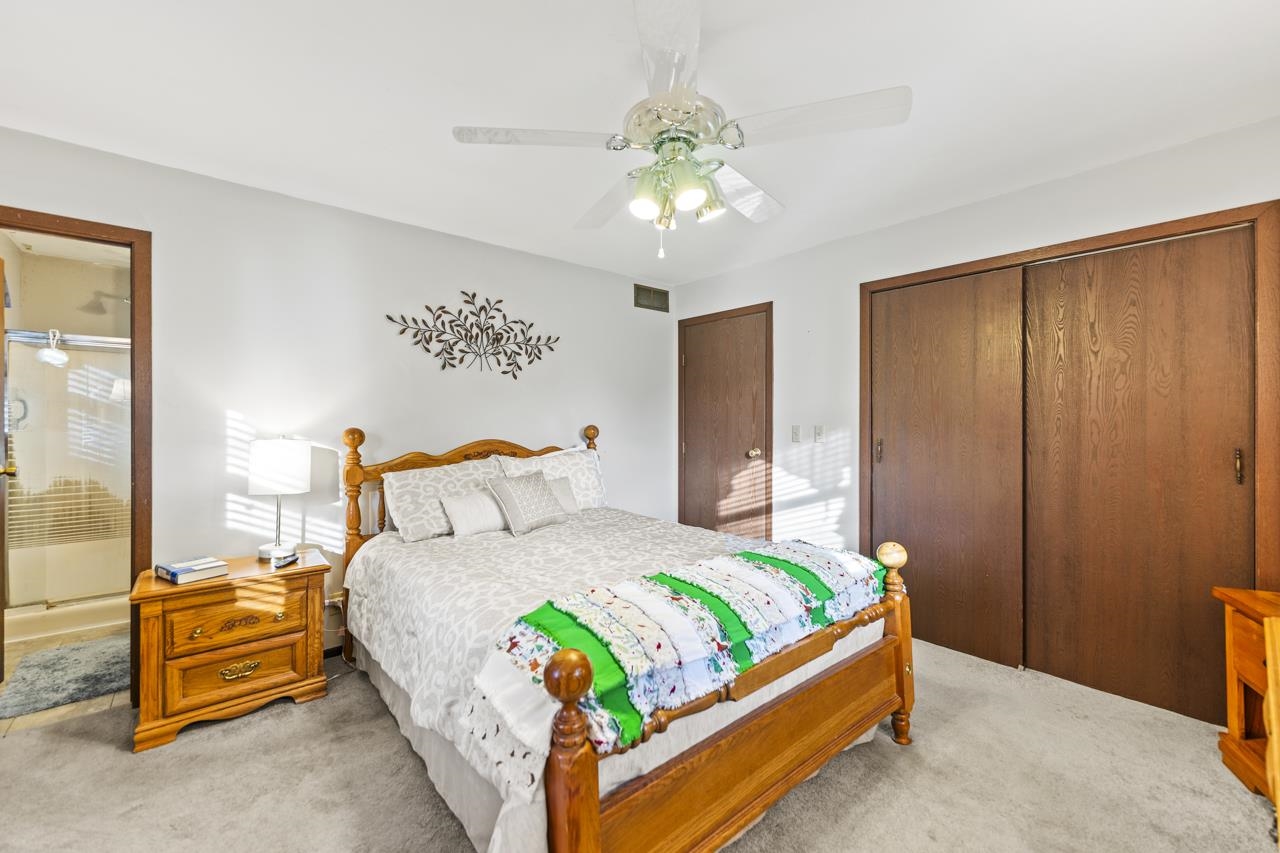 295 Forestcliff Court Lake Summerset, IL 61019 - Photo 13 of 30 a bedroom with a bed and a chandelier