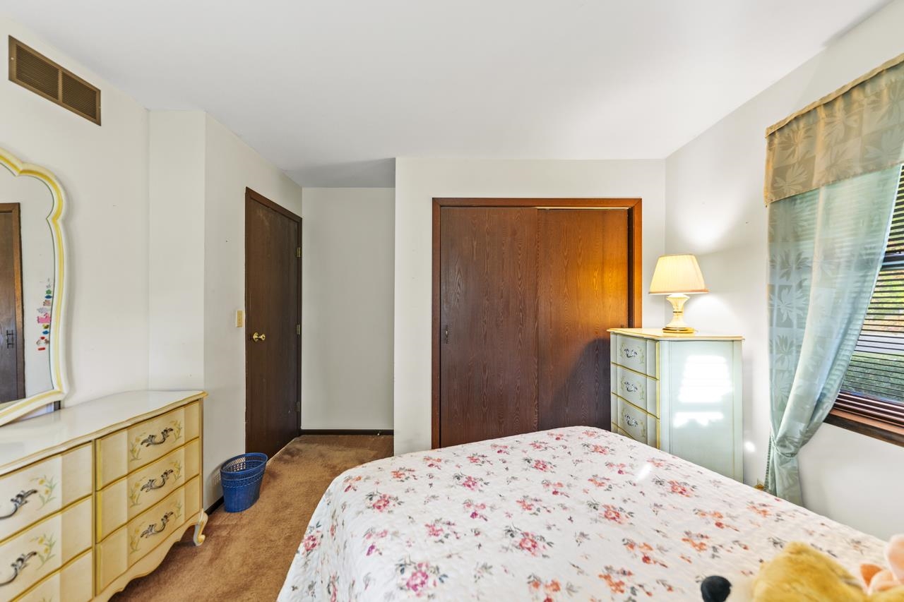 295 Forestcliff Court Lake Summerset, IL 61019 - Photo 19 of 30 a bedroom with a bed and wooden floor