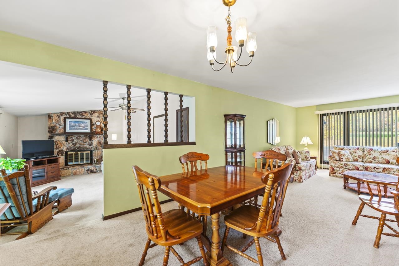 295 Forestcliff Court Lake Summerset, IL 61019 - Photo 7 of 30 a dining room with furniture a chandelier and wooden floor