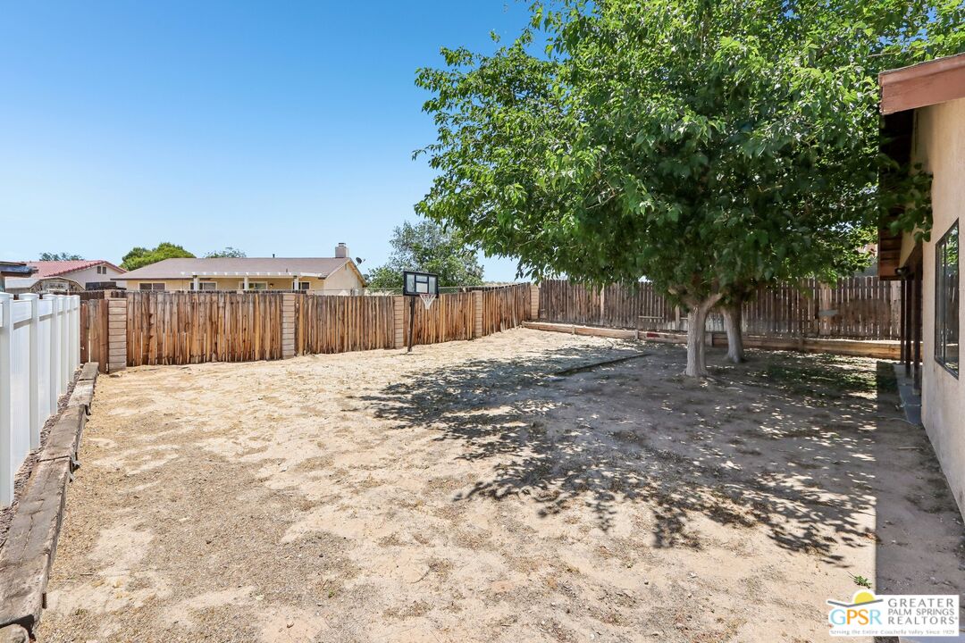 13819 Rivers Edge Road Helendale, CA 92342 - Photo 23 of 31 a view of a backyard with large trees