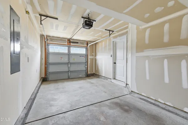 an empty room with closet and windows